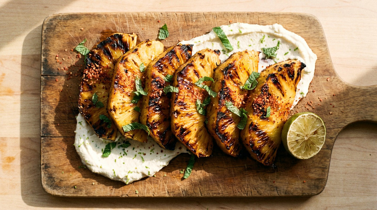 Charred pineapple wedges with Chooki's Chilli Chicken Salt and whipped lime ricotta on a wooden board