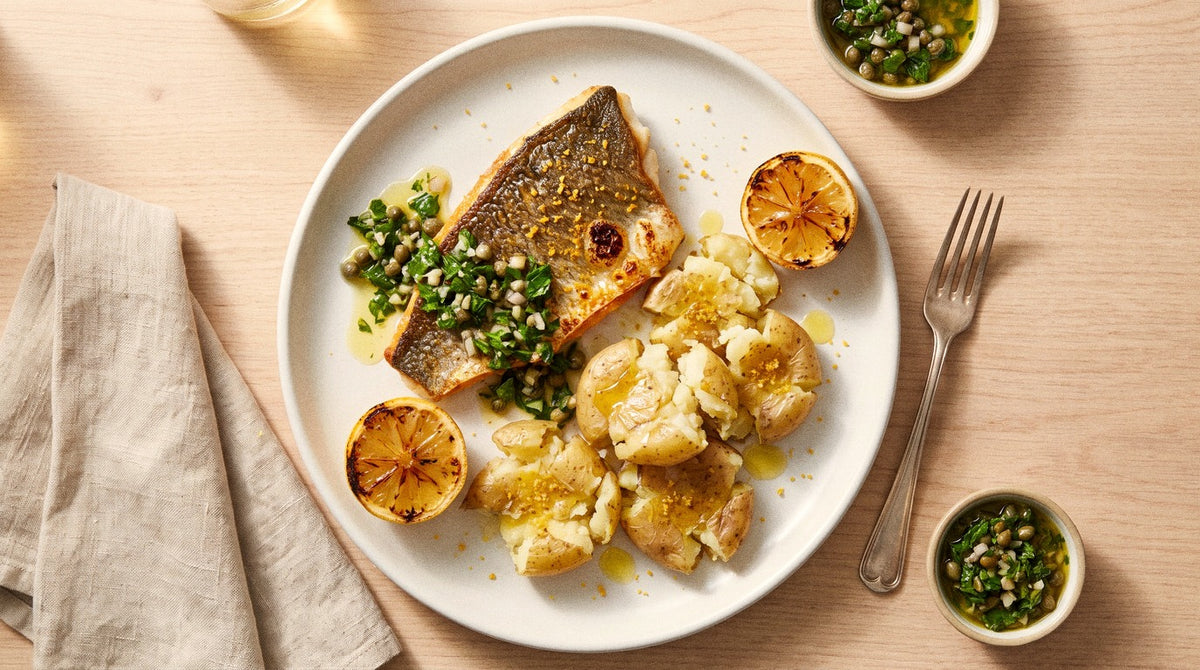 Crispy-skin barramundi with crushed new potatoes and parsley caper salsa seasoned with Chooki's Vinegar Chicken Salt on a white plate